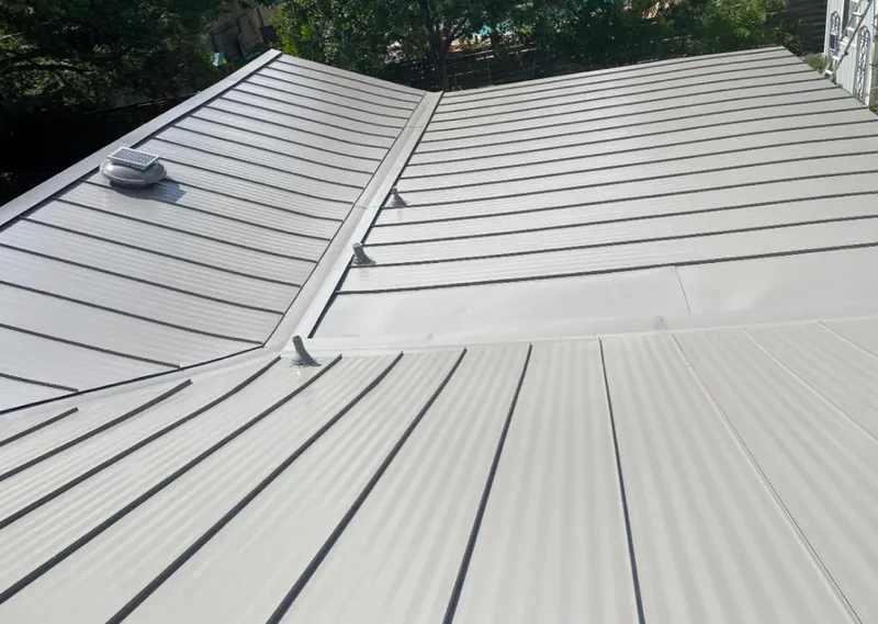Solar attic fan installed on a metal roof for Roof Ventilation in Kirkwood