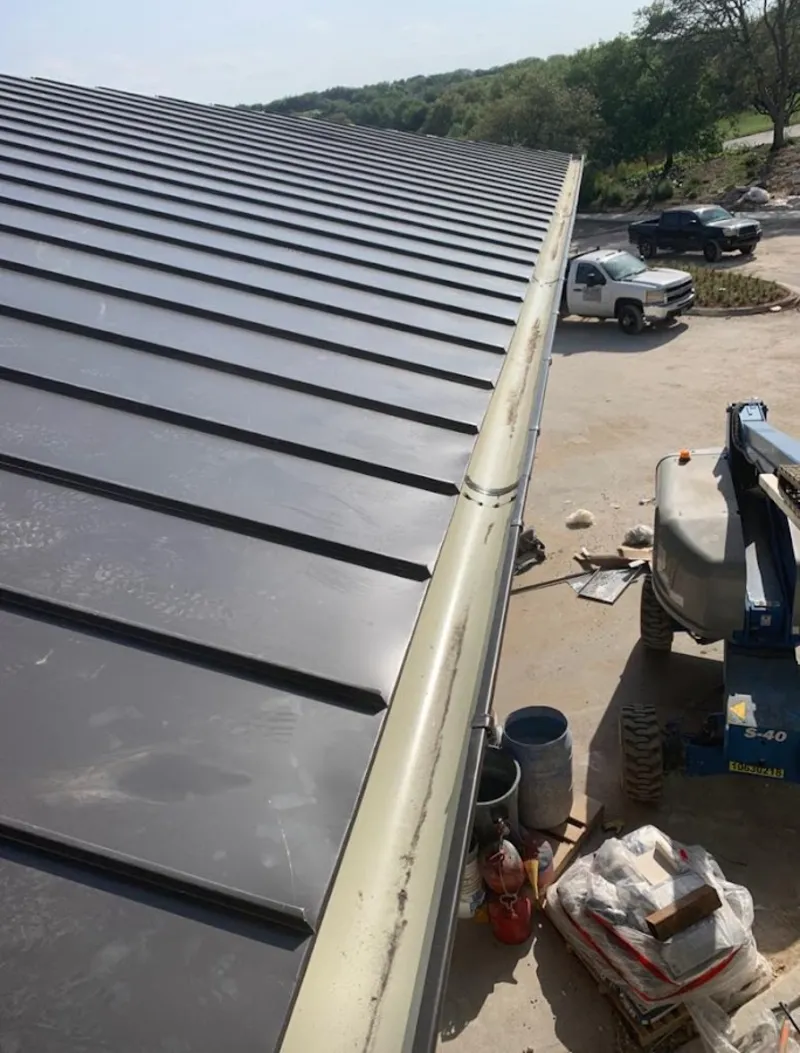 Standing seam panel and gutter detail on a metal roofing jobsite in Kirkwood